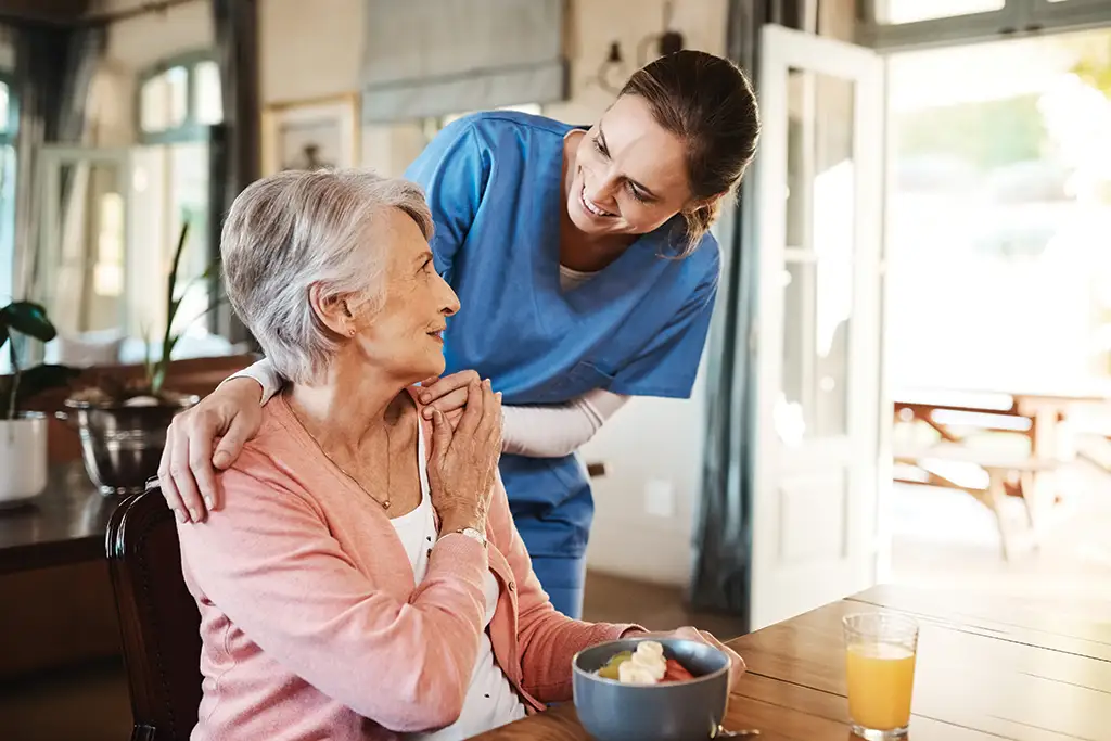 A senior woman hugging her respite care, caregiver.